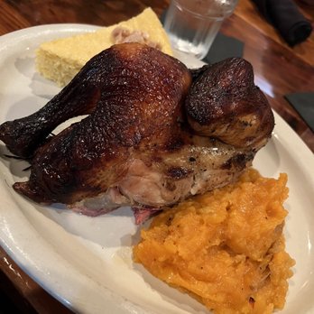 Flying Mango signature dishes  Wood-Fired Jerk Chicken, Smoked Baby Back Ribs with Mango BBQ Sauce, Caribbean Black Beans and Rice, daily fresh fish specials.